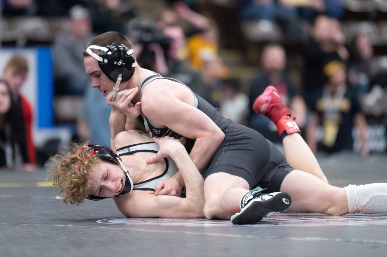 Climax-Scotts/Martin's Logan Gilbert grapples with St. Louis' Owen Fogel during the MHSAA State wrestling tournament at Wings Stadium in Kalamazoo on Friday, Feb. 23, 2024.