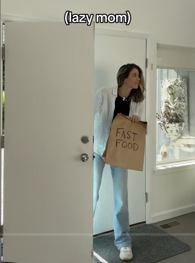Mom walking into a room holding a fast-food bag with caption "lazy mom"