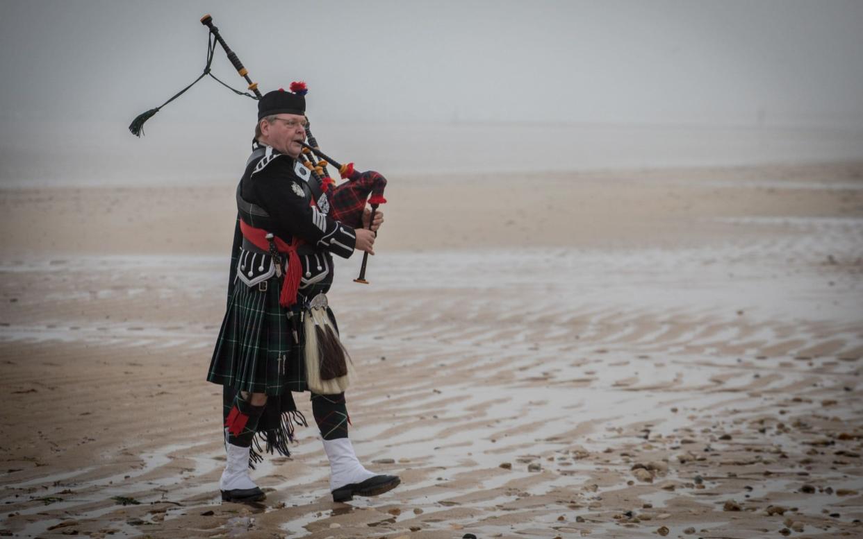 Ceremonial piper Tosh McDonald plays a restored set of Bill Millin pipes on Sword Beach at Colleville-Montgomery, on June 8, 2018  - Getty Images Europe