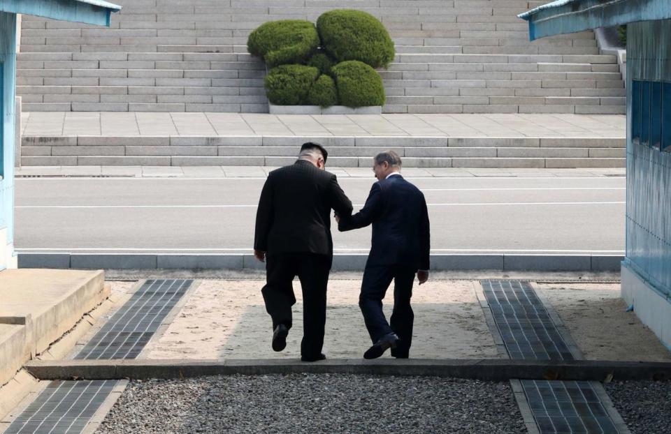 The invite is designed to highlight ongoing peace talks between North and South Korea. Kim, left, is pictured with Moon, right (EPA)