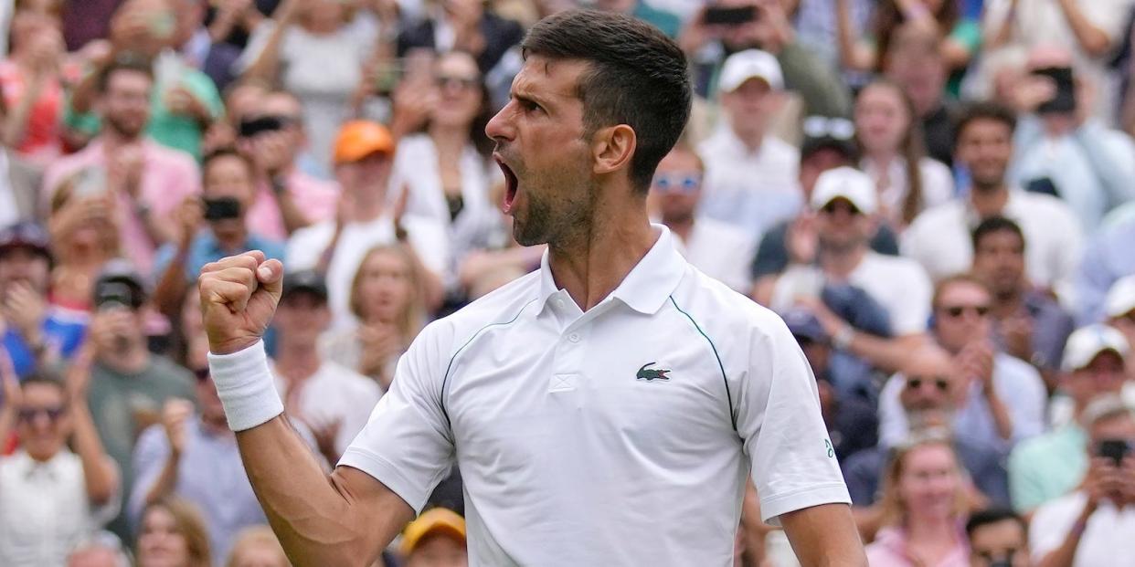 Novak Djokovic pumps his fist and yells at the crowd at Wimbledon.