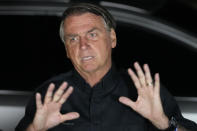 Brazilian President Jair Bolsonaro, who is running for another term, gestures during a press conference after general election polls closed in Brasilia, Brazil, Sunday, Oct. 2, 2022. (AP Photo/Eraldo Peres)