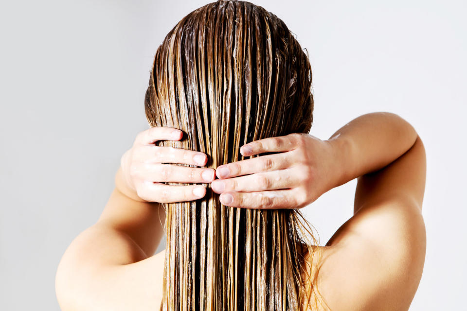 A person touching their wet hair