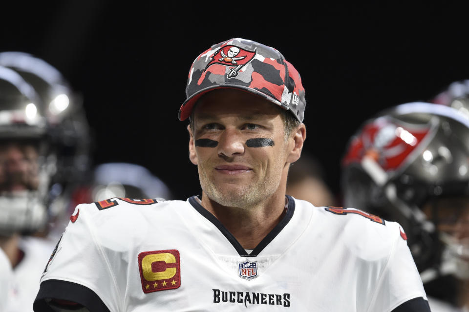 FILE - Tampa Bay Buccaneers quarterback Tom Brady (12) smiles during warmups before an NFL football game, Sunday, Jan. 8, 2023, in Atlanta. Brady, who won a record seven Super Bowls for New England and Tampa, has announced his retirement, Wednesday, Feb. 1, 2023. (AP Photo/Hakim Wright Sr., File)