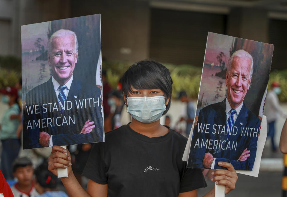 A demonstrators displays pictures of president Joe Biden during a protest against the military coup in Yangon, Myanmar, Wednesday, Feb. 17, 2021. The U.N. expert on human rights in Myanmar warned of the prospect for major violence as demonstrators gather again Wednesday to protest the military's seizure of power. (AP Photo)