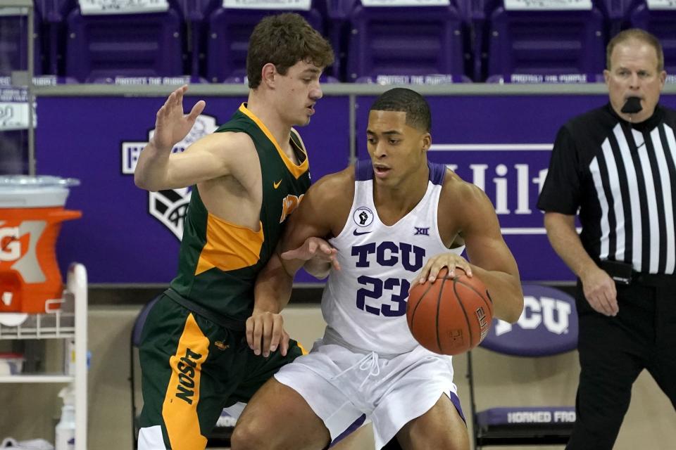 North Dakota State forward Rocky Kreuser (34) defends as TCU forward Jaedon LeDee (23) works for a shot opportunity in the first half of an NCAA college basketball game in Fort Worth, Texas, Tuesday, Dec. 22, 2020. (AP Photo/Tony Gutierrez)