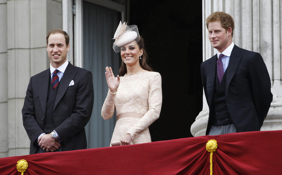 The Duchess of Cambridge waves from the balcony of Buckingham Palace as William and Harry look on, during the Queen's Diamond Jubilee on June 5, 2012. (Photo: Stefan Wermuth / Reuters)