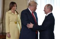 <p>U.S. President Donald Trump shakes hands with Russia’s President Vladimir Putin next to U.S. First Lady Melania Trump ahead a meeting in Helsinki, on July 16, 2018. (Photo: Aleksey Nikolskyi/AFP/Getty Images) </p>