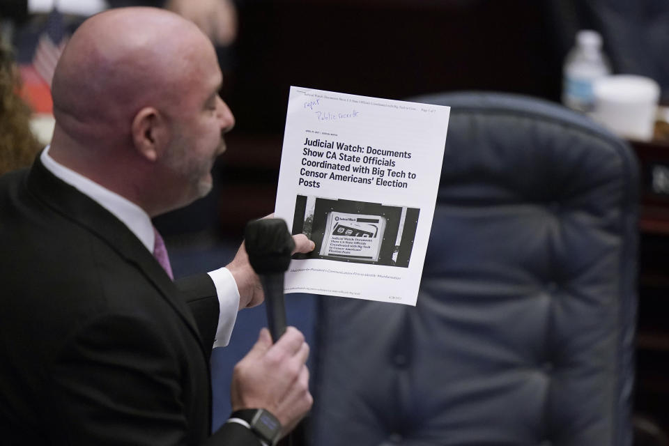 Florida Rep. Blaise Ingoglia holds up an article from Judicial Watch, as he speaks during a legislative session, Wednesday, April 28, 2021, at the Capitol in Tallahassee, Fla. (AP Photo/Wilfredo Lee)