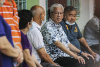Malaysian caretaker Prime Minister Ismail Sabri Yaakob, second from right, waits in a line with other voters to cast his ballots at a polling station during the 15th Malaysian general election in Bera, Pahang, Malaysia, Saturday, Nov. 19, 2022. Malaysians began casting ballots Saturday in a tightly contested national election that will determine whether the country's longest-ruling coalition can make a comeback after its electoral defeat four years ago. (AP Photo/Ahmad Yusni)