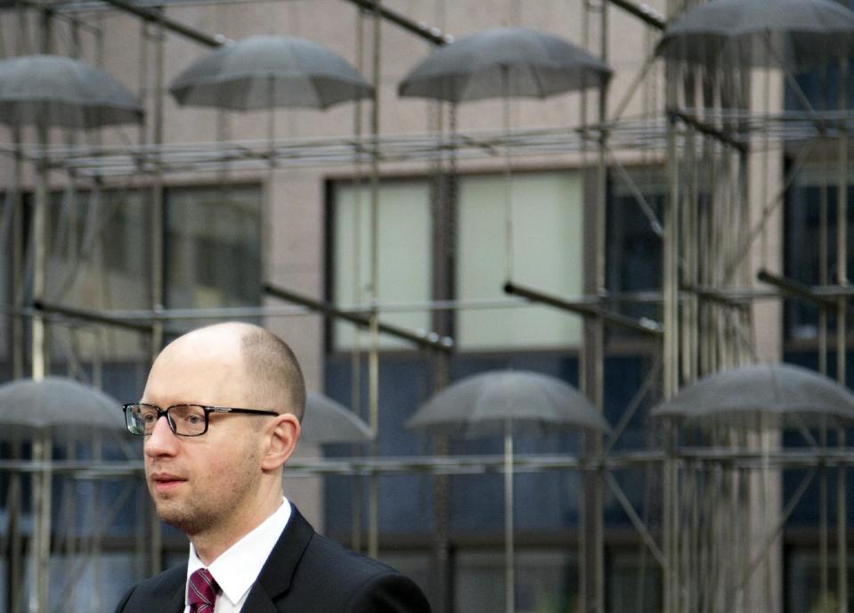 Ukrainian Prime Minister Arseniy Yatsenyuk arrives for an EU summit in Brussels on Friday, March 21, 2014. Ukraine’s prime minister has pulled his nation closer into Europe’s orbit, signing a political association agreement with the EU at a summit of the bloc’s leaders. Friday’s agreement between Prime Minister Arseniy Yatsenyuk and the EU leaders was part of the pact that former President Viktor Yanukovych backed out of last November in favor of a $15 billion bailout from Russia. That decision sparked the protests that ultimately led to his downfall and flight last month, setting off one of Europe’s worst political crises since the Cold War. (AP Photo/Virginia Mayo)