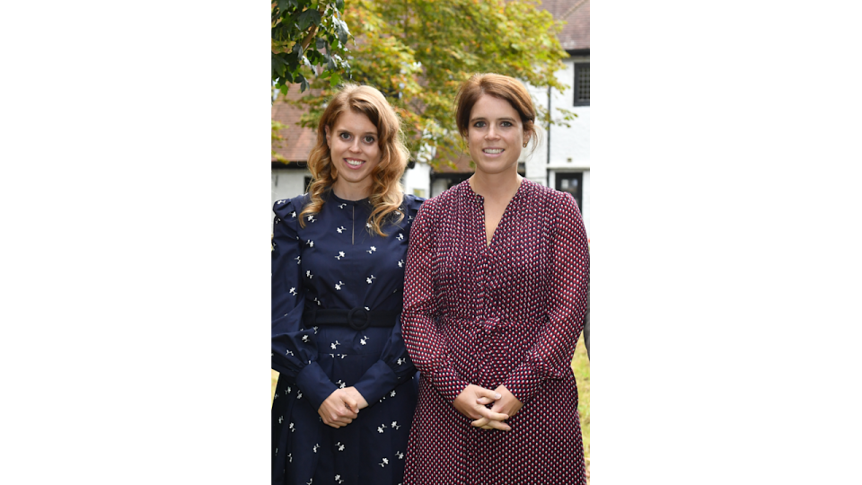 beatrice and eugenie pose in floral dresses outside