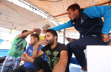 Young people openly discuss plans to make an illegal boat trip, with Reuters journalists, as they share tales of frustration to land a decently paid job, in Port Monastir, Tunisia October 3, 2017. Picture taken October 3, 2017. REUTERS/Zoubeir Souissi