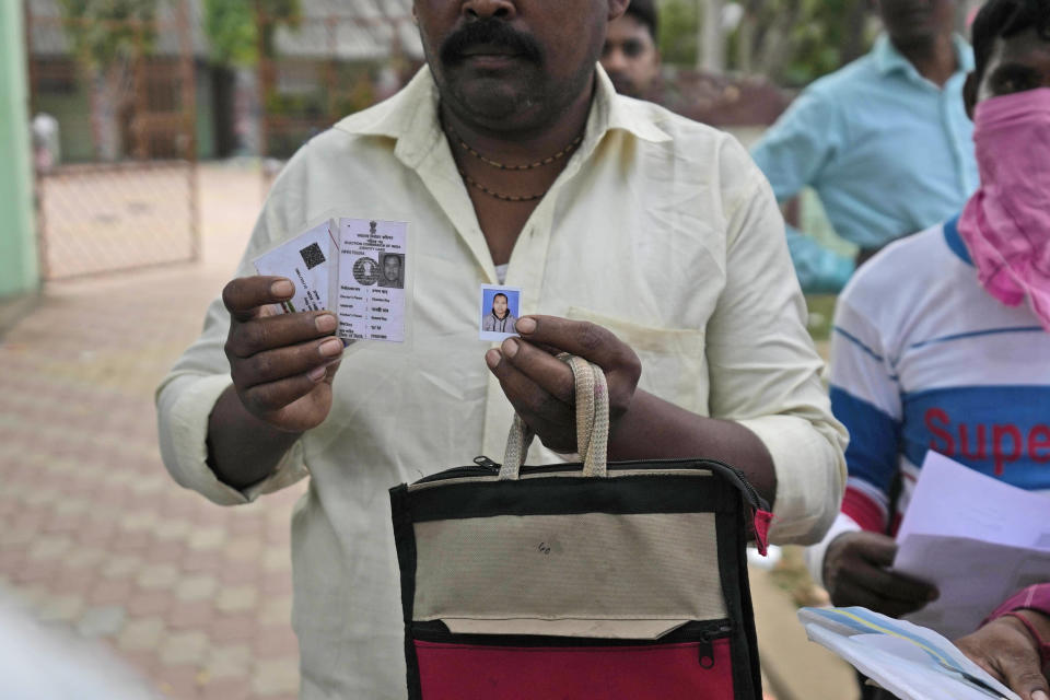 A person shows photo of his relative who was traveling in the train that derailed while looking for him at the site of the accident, in Balasore district, in the eastern Indian state of Orissa, Sunday, June 4, 2023. Indian authorities end rescue work and begin clearing mangled wreckage of two passenger trains that derailed in eastern India, killing over 300 people and injuring hundreds in one of the country’s deadliest rail crashes in decades. (AP Photo/Rafiq Maqbool)