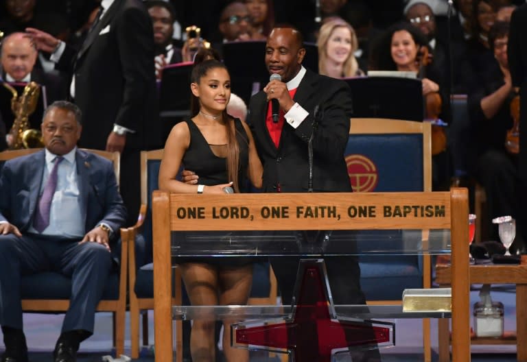 After her performance, Ariana Grande was congratulated by Bishop Charles H. Ellis III, who placed his arm high above her waist with his fingers pressed against her chest