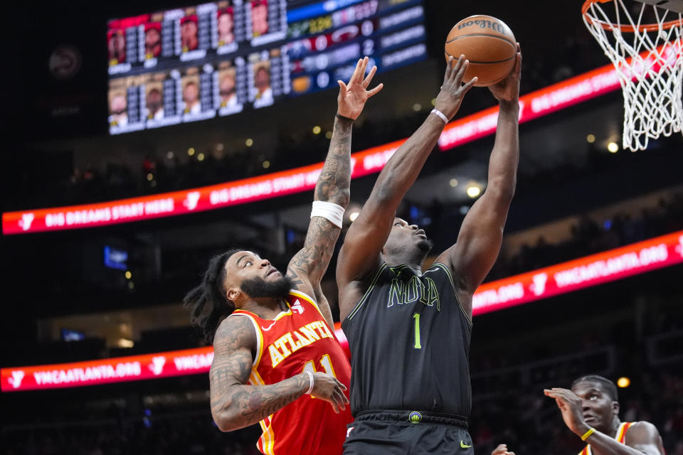 New Orleans Pelicans forward Zion Williamson (1) goes passed Atlanta Hawks forward Saddiq Bey (41) to score during the first half of an NBA basketball game Sunday, March 10, 2024, in Atlanta. (AP Photo/John Bazemore)