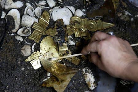 Alejandra Molina, an archaeologist with the National Institute of Anthropology and History (INAH), works at a site where a sacrificed young wolf elaborately adorned with some of the finest Aztec gold has been discovered adjacent to the Templo Mayor, one of the main Aztec temples, in Mexico City, Mexico June 22, 2017. Picture taken June 22, 2017. REUTERS/Henry Romero