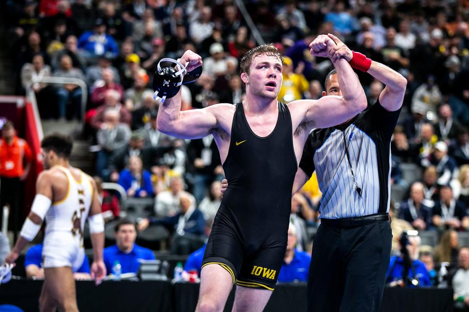 Iowa's Jacob Warner, right, reacts after scoring a decision against Wyoming's Stephen Buchanan at 197 pounds in the semifinals during the fourth session of the NCAA Division I Wrestling Championships last year.