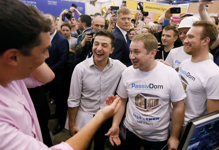 Ukraine's President Volodymyr Zelenskiy (C) reacts while speaking with participants of an IT conference in Kiev, Ukraine May 23, 2019. REUTERS/Valentyn Ogirenko