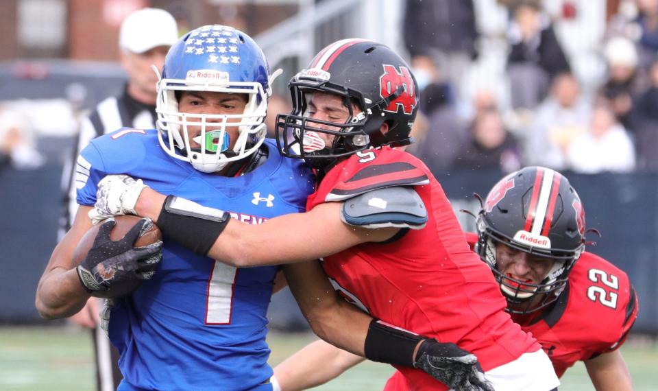 Quincy's Jarod Walker carries the football during the 89th Thanksgiving game against North Quincy at Veteran's Memorial Stadium in Quincy on Thursday, Nov. 25, 2021.