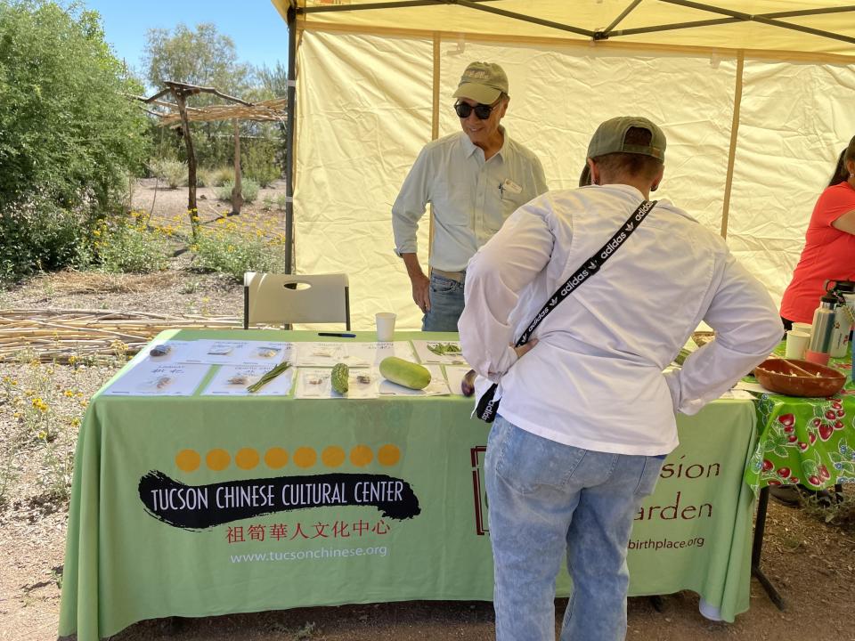 Fe Tom, Mission Garden board member, showcases Chinese vegetables and heirloom varieties grown in Tucson, on the Seed Swap event of May 27, 2023.