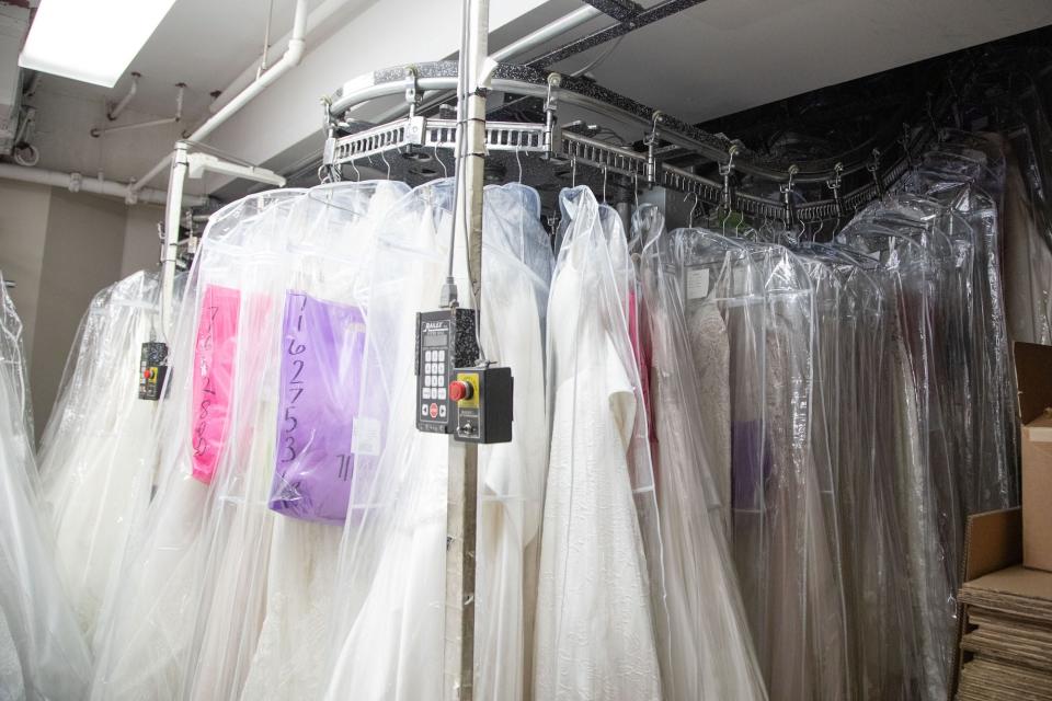 A machine with wedding dresses hanging from a rack.