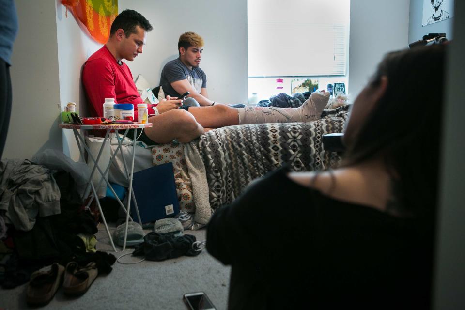Rancel Valdez is surrounded by his friend Cristian Mendez, roommate Kimberly Phillips and Megan Estrada as he describes how he was assaulted at an off-campus party near the University of Delaware on Friday night in Newark.