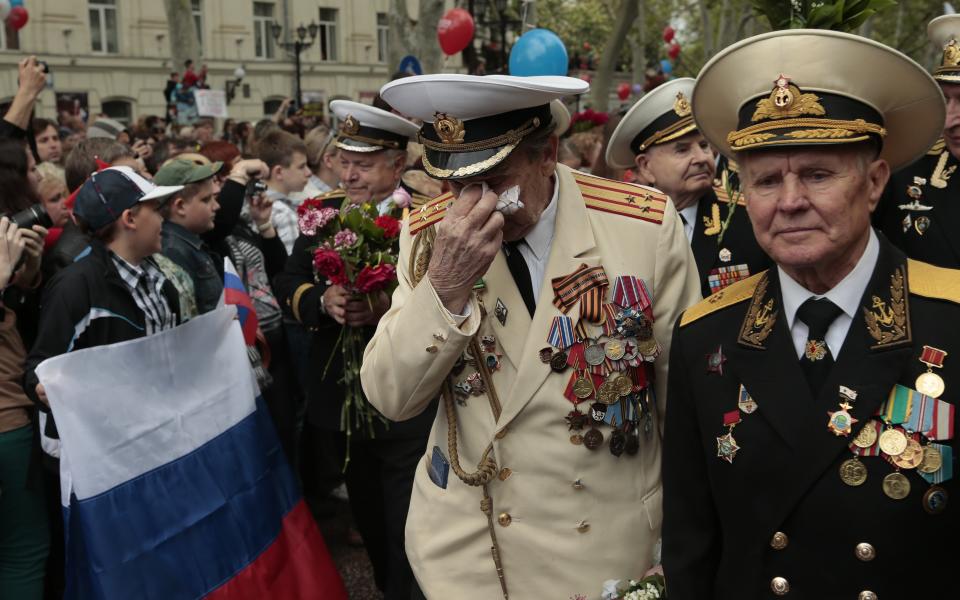 WWII veterans walk during a Victory Day military parade in Sevastopol, Crimea, Friday, May 9, 2014. Crimea, which hosts a major Russian Black Sea Fleet base, is also set to hold a massive navy parade in the port of Sevastopol, celebrating the Russian takeover. (AP Photo/Ivan Sekretarev)