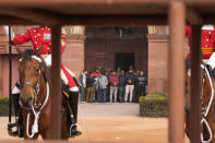 People watch as Egyptian President Abdel Fattah El-Sisi inspects a joint military guard of honour during his ceremonial reception at the Indian presidential palace, in New Delhi, India, Wednesday, Jan. 25, 2023. El-Sisi will be the Chief Guest on the country's annual Republic Day parade on Thursday. (AP Photo/Manish Swarup)