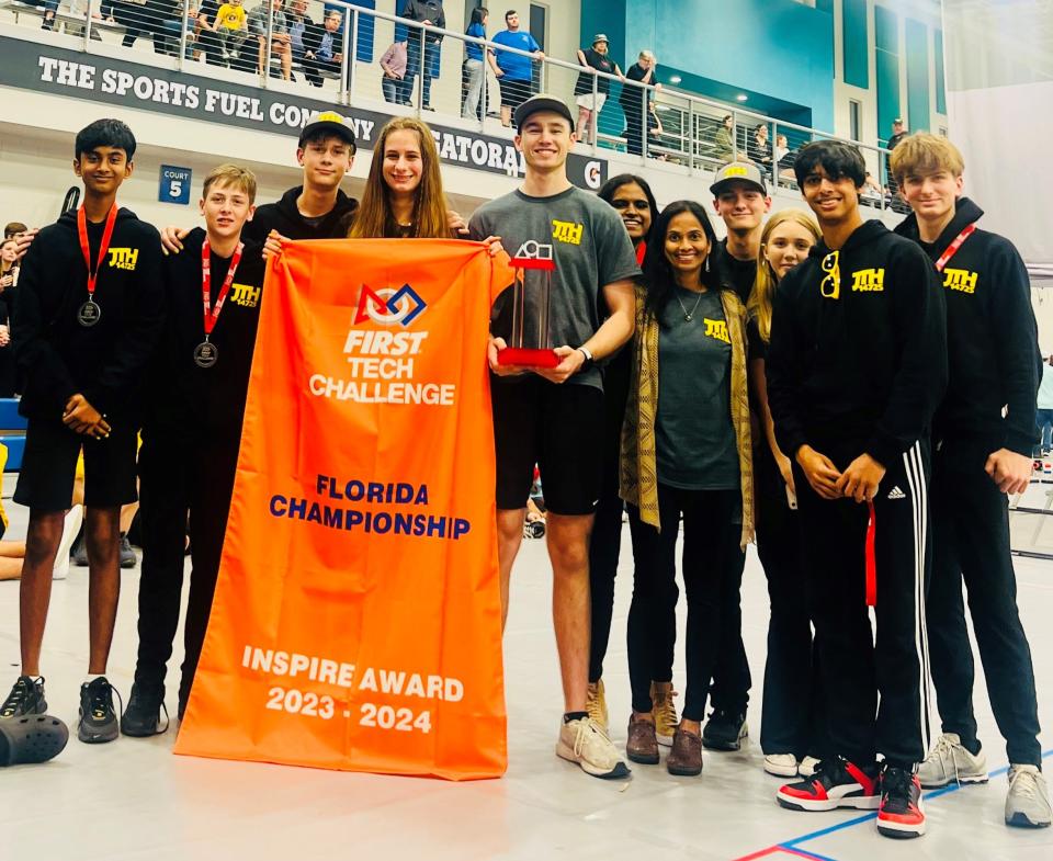 Members of the Fort Myers robotics team Java The Hutts pose with their awards banner in March 2024 after winning the Inspire Award at the FIRST Tech Challenge Florida Championship in Winter Haven.