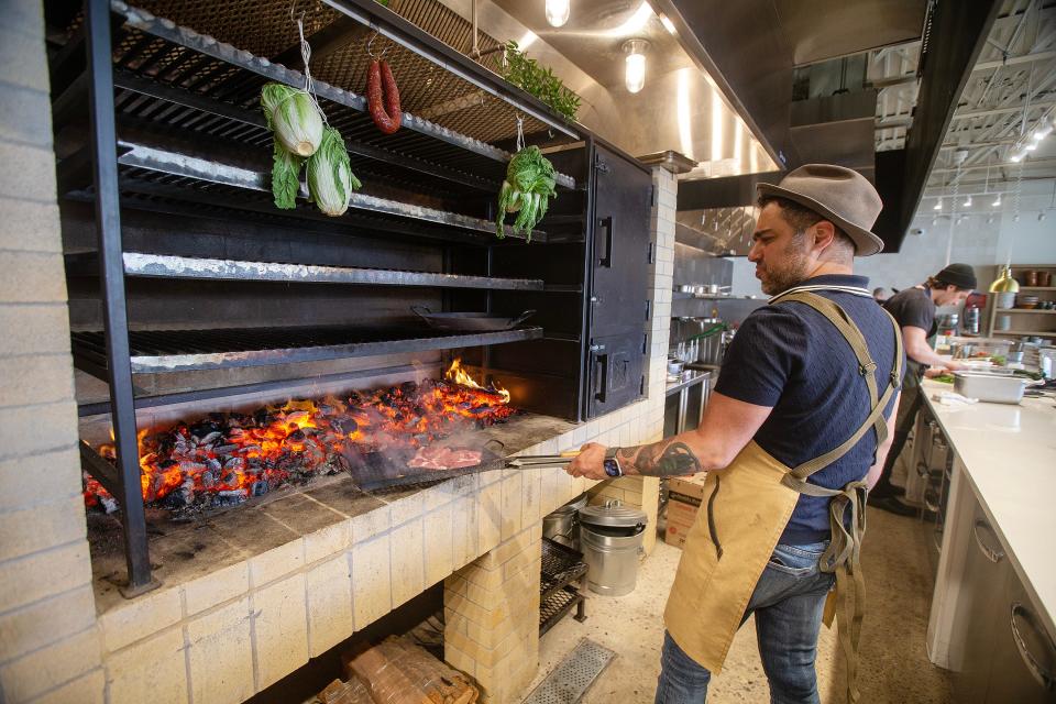 David Viana, executive chef, prepares pork steak in the open fire hearth oven at Lita in Aberdeen.