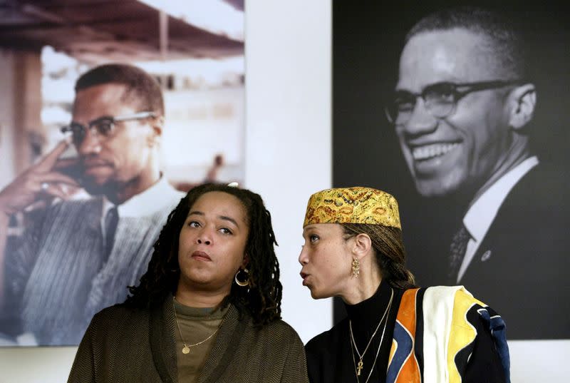 FILE PHOTO: Attallah Shabazz (R) and Malaak Shabazz, two of the six daughters of the late Malcolm X sit togethe..