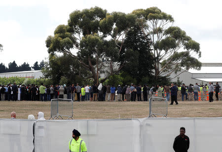 People attend the burial ceremony for the victims of the mosque attacks at the Memorial Park Cemetery in Christchurch, New Zealand March 20, 2019. REUTERS/Jorge Silva