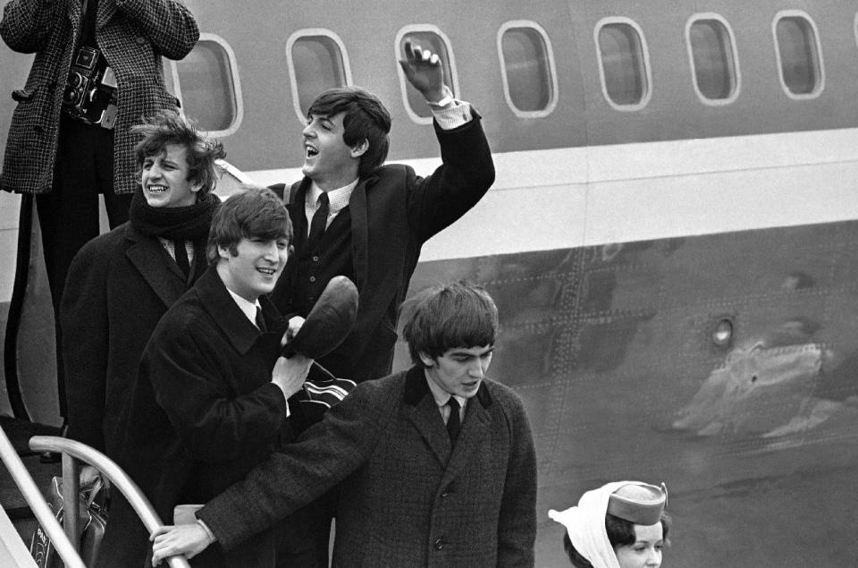 FILE - In this this Feb. 7, 1964 file photo, Britain’s Beatles arrive at John F. Kennedy Airport, in New York, after their flight from London. From left to right, Ringo Starr, John Lennon, Paul McCartney and George Harrison. The Beatles would go on to take America by storm, and rock 'n' roll was never the same. (AP Photo/File)