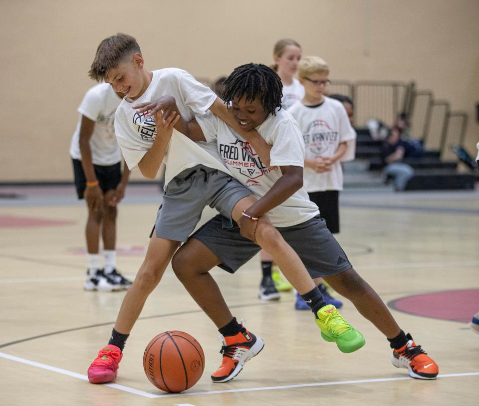 Cooper Pozzi, left and Kamden Morris, right participate in a defensive drill during day one of Fred VanVleet summer camp on Saturday, June 25, 2022, at Auburn High School in Rockford.