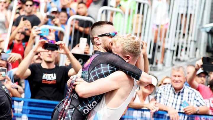 Cody Beals and partner James Cooper embrace after Cody won the 2019 Ironman Mont-Tremblant triathlon. Photo: Al Bello/Getty Images