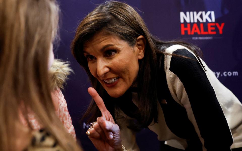 Republican presidential candidate and former U.S. Ambassador to the United Nations Nikki Haley speaks with an attendee during an Iowa Caucus campaign event at Country Lane Lodge in Adel,