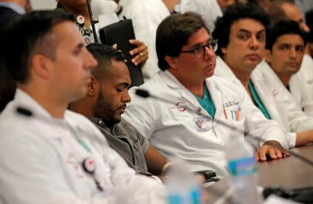 Gunshot survivor Angel Colon is surrounded by doctors as he listens to remarks at a news conference at the Orlando Regional Medical Center on the shooting at the Pulse gay nightclub in Orlando, Florida, June 14, 2016. REUTERS/Jim Young/File Photo