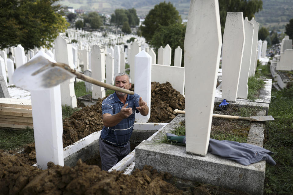 A man throws a shovel after digging graves for COVID-19 victims at the Bare cemetery in Sarajevo, Bosnia, Friday, Sept. 24, 2021. Public mistrust of authorities in corruption-plagued Bosnia has created an opening for anti-vaccination movement even though the Balkan nation has the highest rate in Europe of coronavirus deaths and faces a growing number of new infections. So far, despite an abundance of coronavirus vaccines in Bosnia, just under 13 percent of its 3.3 million people had been fully immunized against Covid-19. (AP Photo)