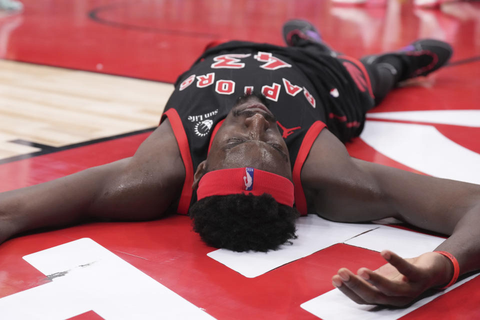 Toronto Raptors' Pascal Siakam lies on the court after being fouled during his team's loss to the Utah Jazz in NBA basketball game action in Toronto, Saturday, Dec. 23, 2023. (Chris Young/The Canadian Press via AP)