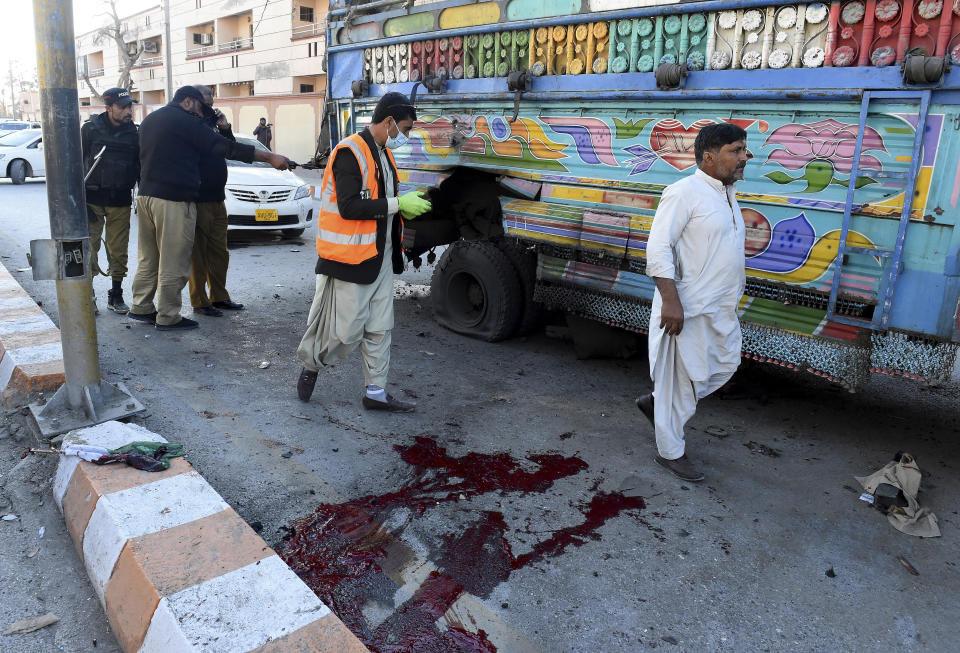 FILE - In this Feb. 5, 2021, file photo, police officers examine the site of a bomb explosion in Quetta, Pakistan. Militant attacks are on the rise in Pakistan amid a growing religiosity that has brought greater intolerance, prompting one expert to voice concern the country could be overwhelmed by religious extremism. (AP Photo/Arshad Butt, File)