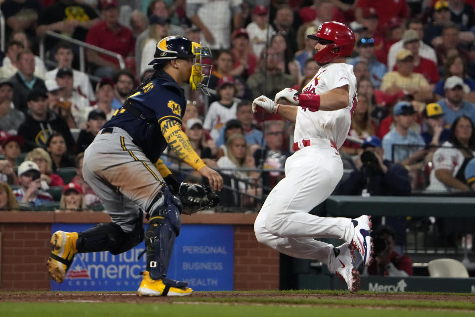 St. Louis Cardinals' Paul Goldschmidt, right, scores past Milwaukee Brewers catcher William Contreras during the sixth inning of a baseball game Monday, May 15, 2023, in St. Louis. (AP Photo/Jeff Roberson)