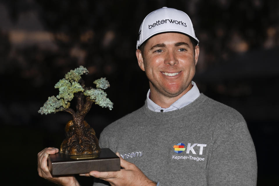 Luke List holds up the championship trophy after winning the the Farmers Insurance Open golf tournament, Saturday, Jan. 29, 2022, in San Diego. (AP Photo/Denis Poroy)