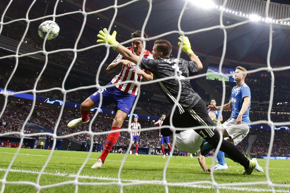 Atletico Madrid's Stefan Savic scores his side's first goal during the Champions League Group D soccer match between Atletico Madrid and Juventus at Wanda Metropolitano stadium in Madrid, Spain, Wednesday, Sept. 18, 2019. (AP Photo/Manu Fernandez)