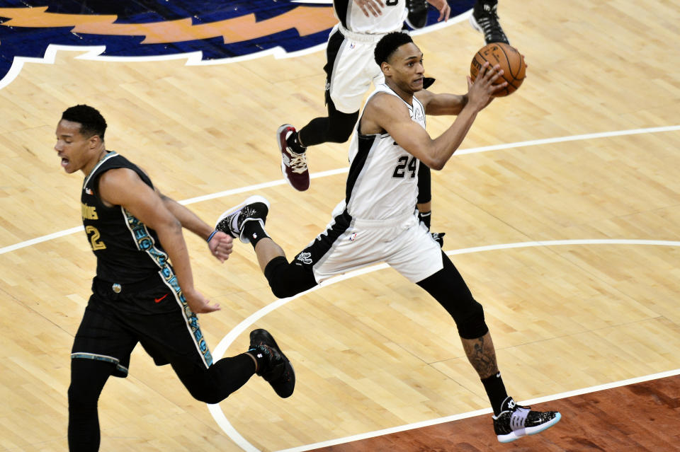 San Antonio Spurs guard Devin Vassell (24) drives to the basket ahead of Memphis Grizzlies guard Desmond Bane (22) during the first half of an NBA basketball Western Conference play-in game Wednesday, May 19, 2021, in Memphis, Tenn. (AP Photo/Brandon Dill)