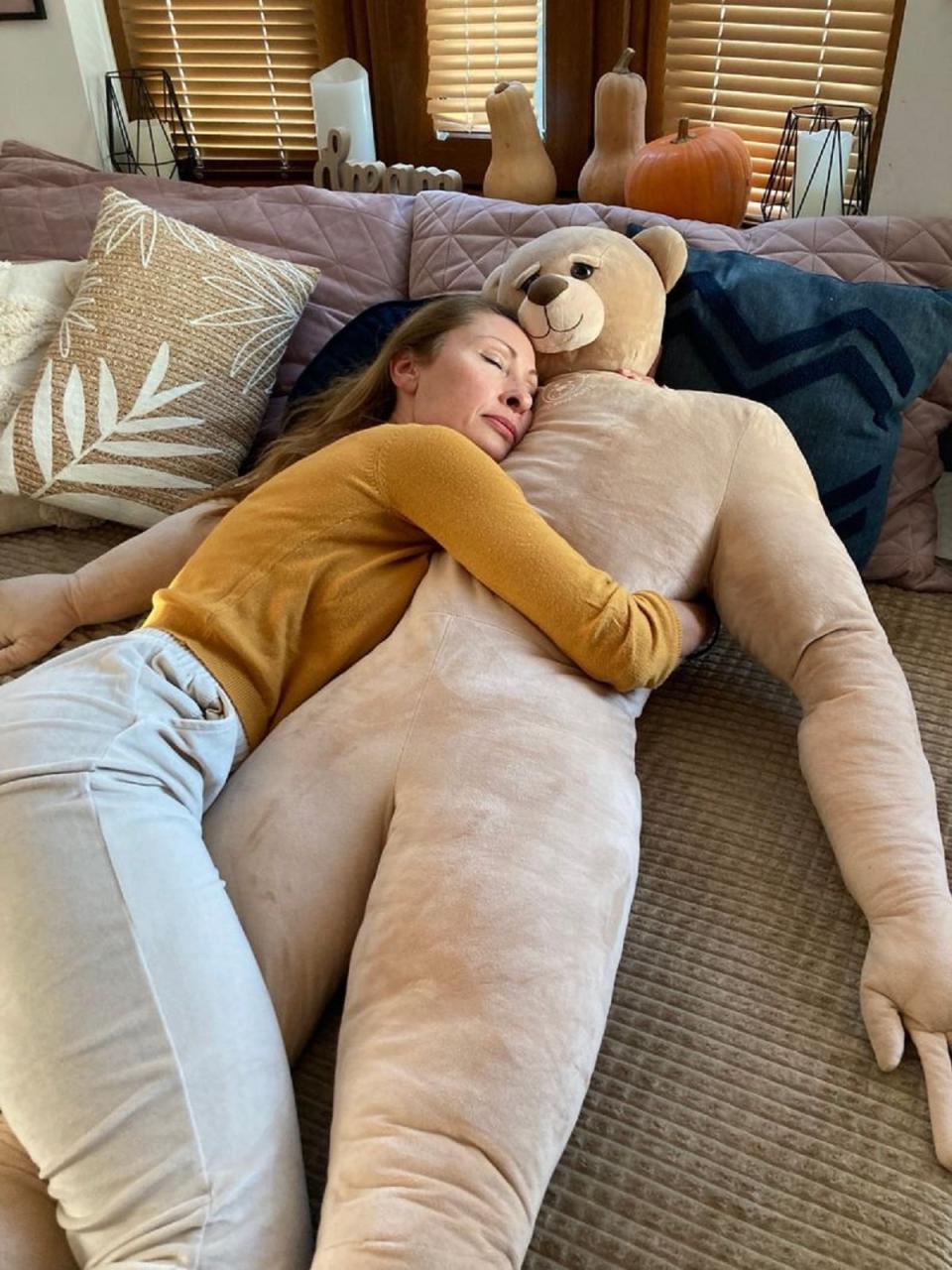Woman cuddles with the Loving Bear Puffy