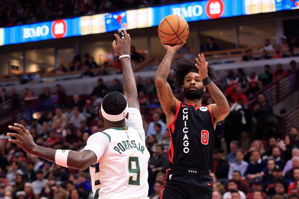 Coby White of the Bulls takes a shot over Bobby Portis of the Bucks during the first half at the United Center on Thursday night.