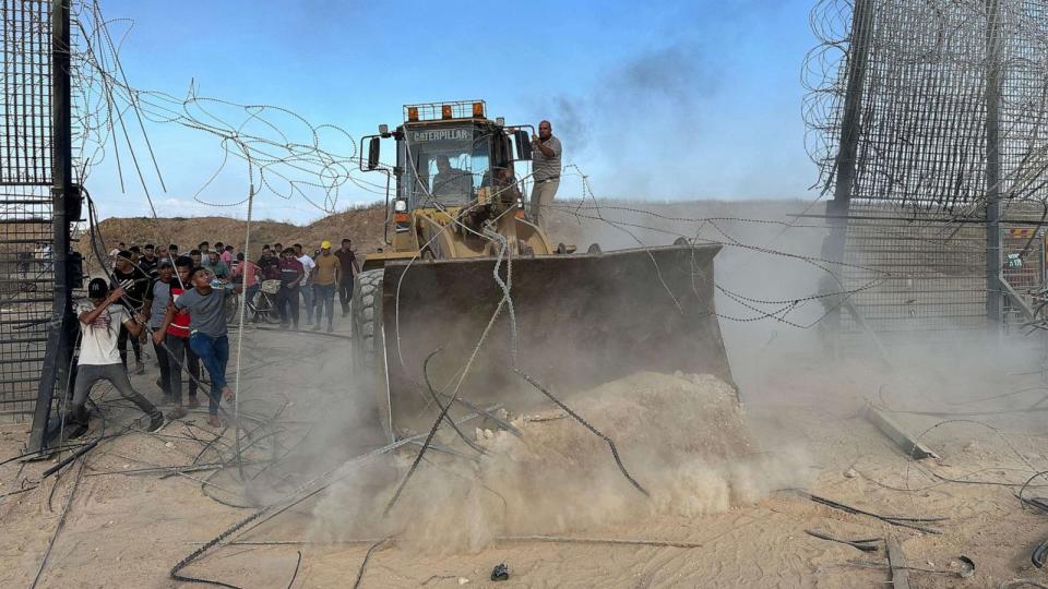 PHOTO: Palestinians cross the border fence with Israel from Khan Yunis in the southern Gaza Strip, on Oct. 7, 2023. (APA Images via ZUMA Press Wire)