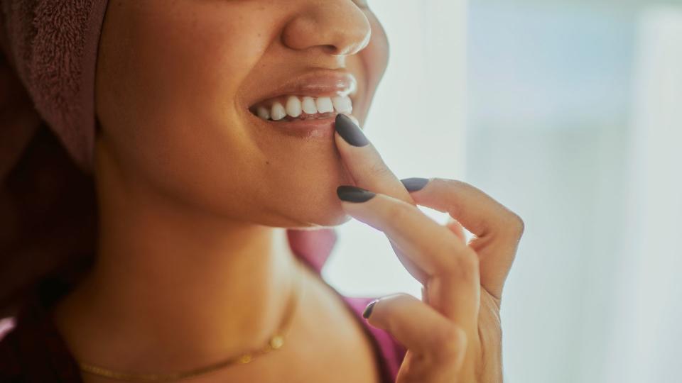 woman applying lip balm