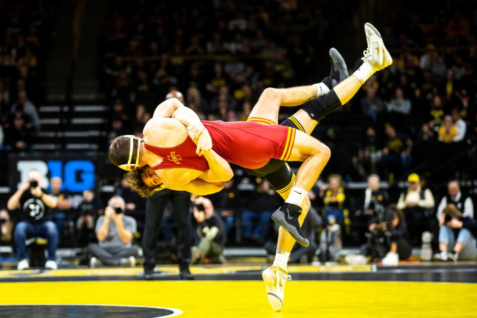 Iowa's Cobe Siebrecht, back, wrestles Iowa State's Jason Kraisser at 157 pounds during a Cy-Hawk Series NCAA men's wrestling dual, Sunday, Dec. 4, 2022, at Carver-Hawkeye Arena in Iowa City, Iowa.